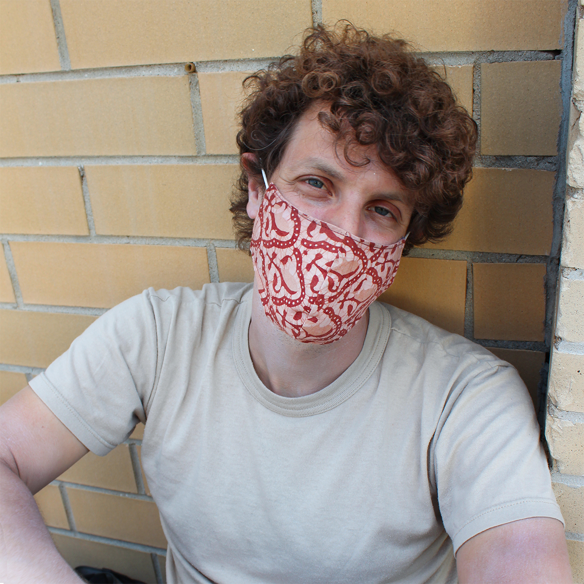 male model wearing pink fabric mask face covering