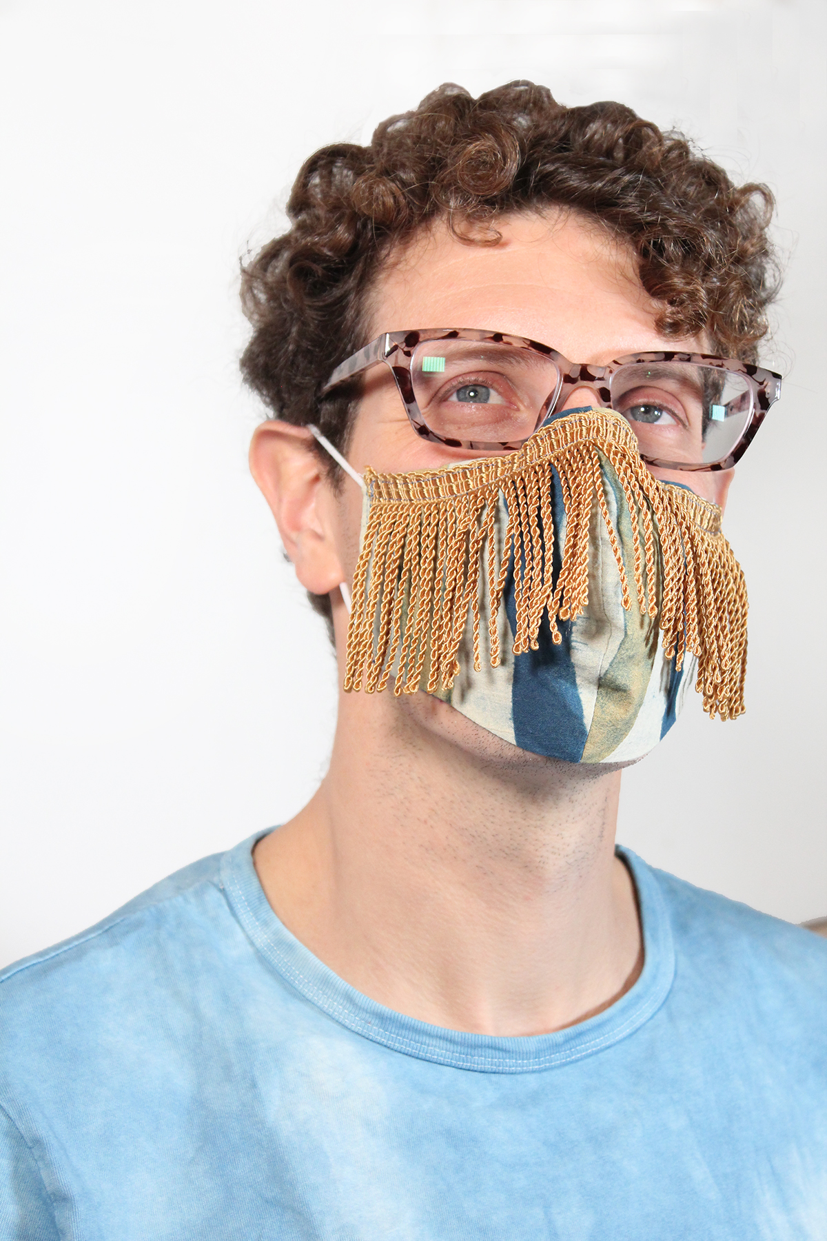 Face covering mask with Gold fringe on male model